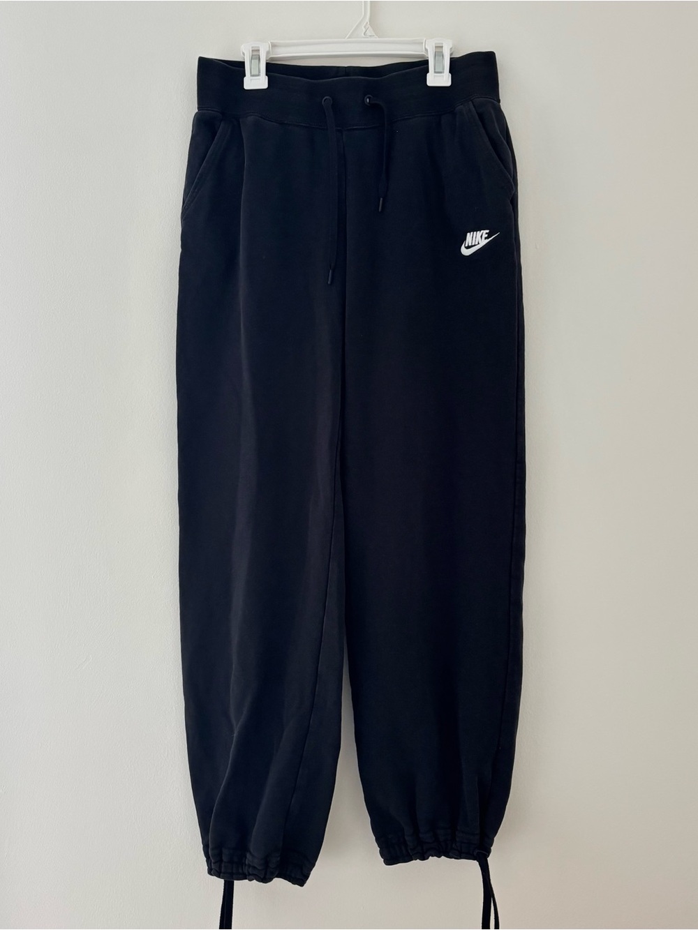 Black Nike sweatpants with drawstring waist and adjustable cuffs
